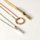 18ct gold charm necklaces, set with diamonds