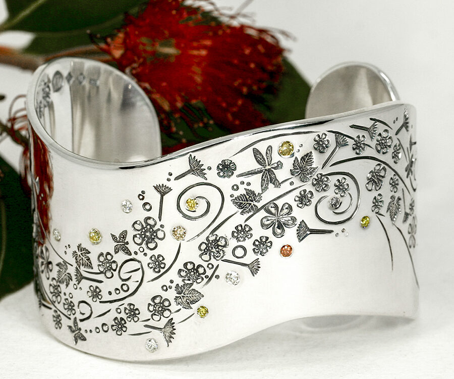Everlasting-summer-wide-sterling-silver-cuff-with-hand-engraved-detail-set-with-assorted-coloured-diamonds-john-miller-design