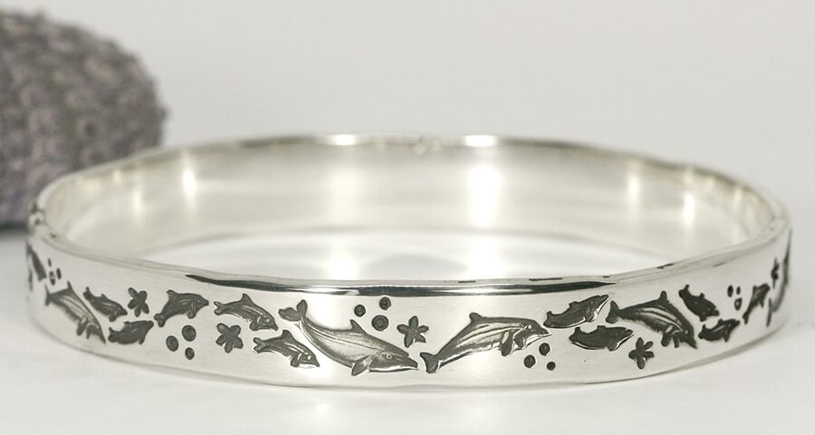 Dolphin delight handcrafted sterling silver bangle featuring dolphins frolicking