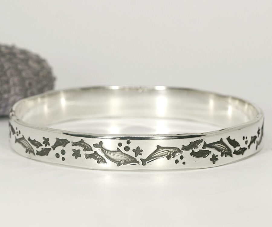 Dolphin delight handcrafted sterling silver bangle featuring dolphins frolicking