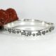 'Turtle Journey' sterling silver bangle with a hammer beat finish and a wavey profile john miller design