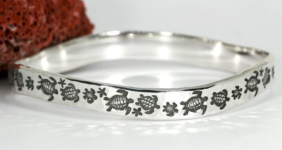 'Turtle Journey' sterling silver bangle with a hammer beat finish and a wavey profile john miller design