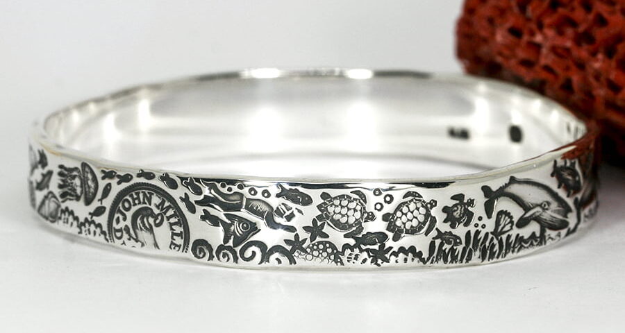 'Drama of the Deep' sterling silver bangle with an underwater theme design john miller design