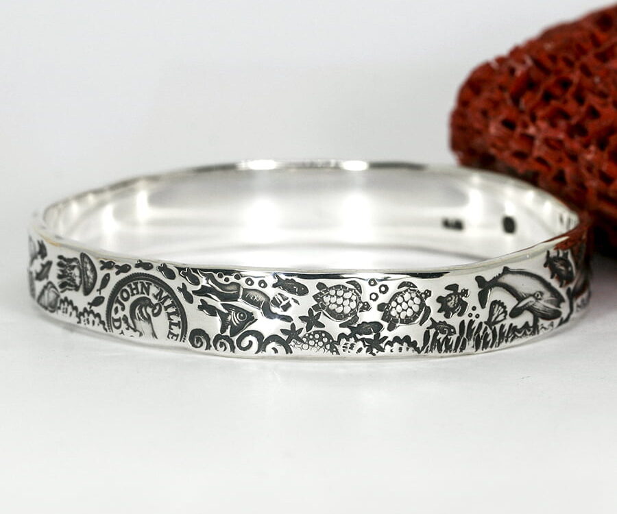 'Drama of the Deep' sterling silver bangle with an underwater theme design john miller design