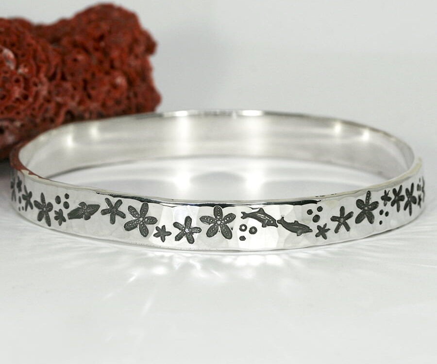 'Starfish Marine' sterling silver bangle with a hammerbeat finish featuring marine life