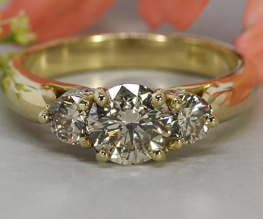 'Romance' 18ct yellow gold ring set with a cognac diamond 2 C2 diamonds white gold under setting set with 6 GSI diamonds john miller design