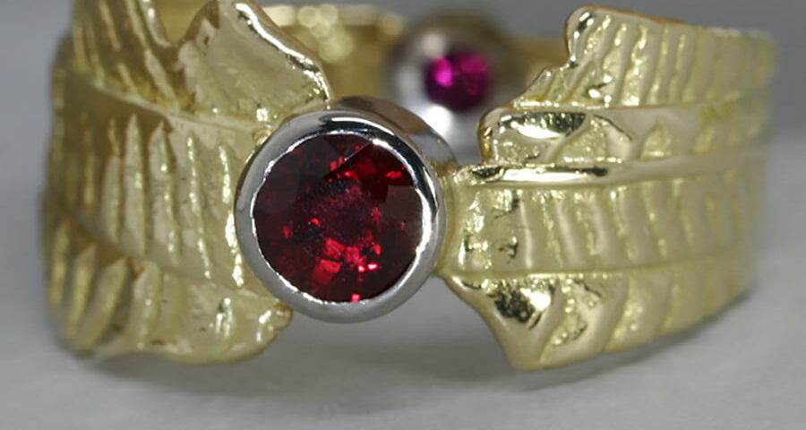 'Ruby Sunrise' 18ct gold patterned ring 2 Burma Rubies totalling 0.75ct set in 18ctwhite gold bezel john miller design