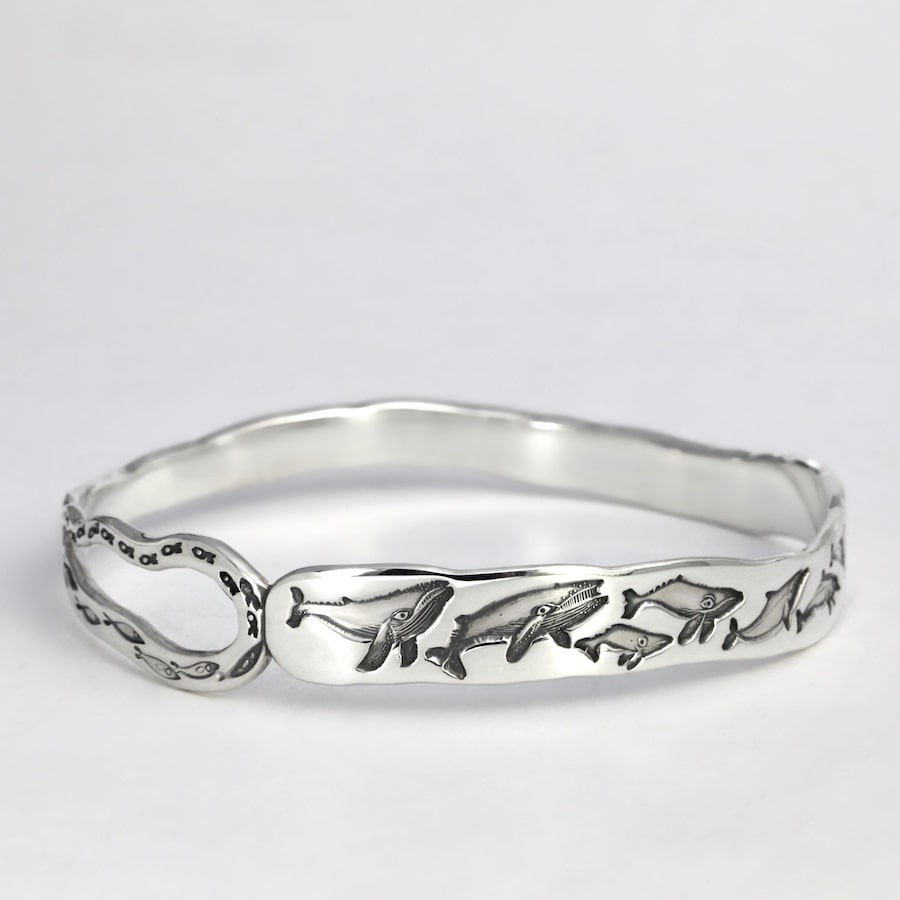 'Oceanic Wave' sterling silver cuff with design of whales dolphins and fish john miller design