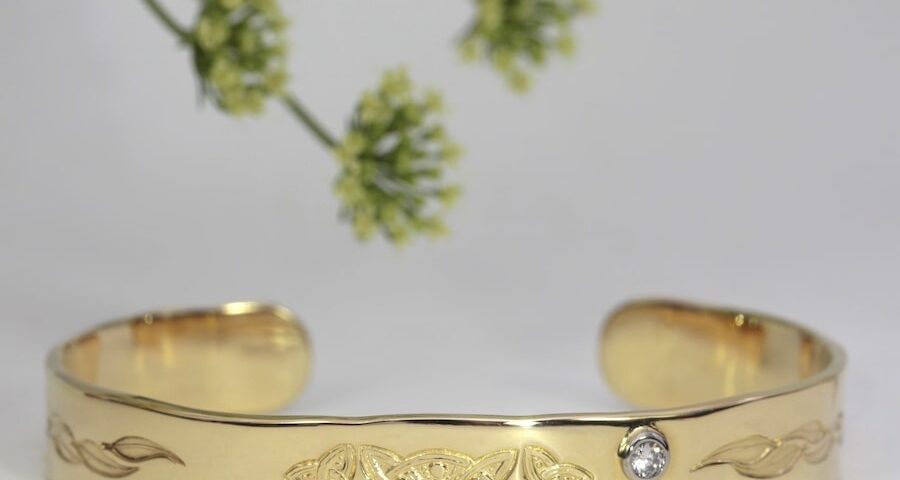 'Argyle Celtic'18ct gold cuff with a 0.12ct VS diamond in 18ct white gold bezel john miller design