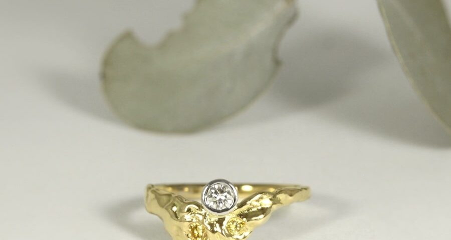 'Fused Golden Delight' 18ct gold ring with a RBC diamond and yellow diamonds in white bezel setting
