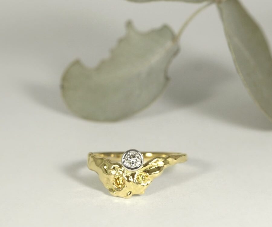 'Fused Golden Delight' 18ct gold ring with a RBC diamond and yellow diamonds in white bezel setting