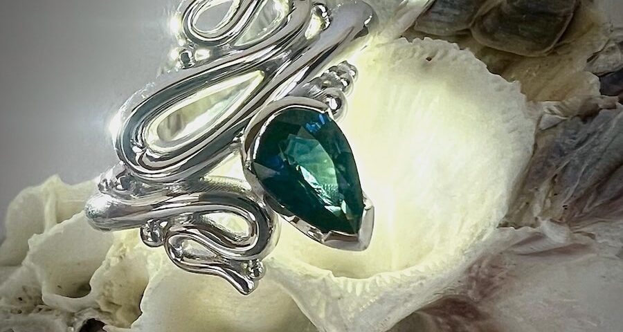 'Ocean Inspired' 9ct white gold ring set with a teal pear sapphire john miller design