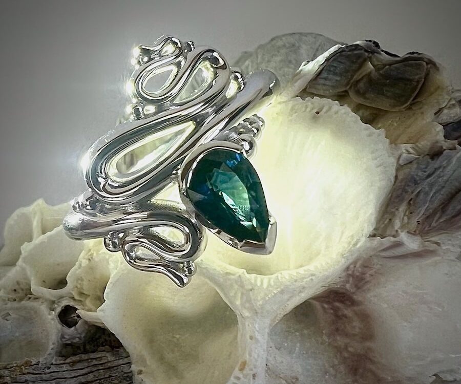 'Ocean Inspired' 9ct white gold ring set with a teal pear sapphire john miller design