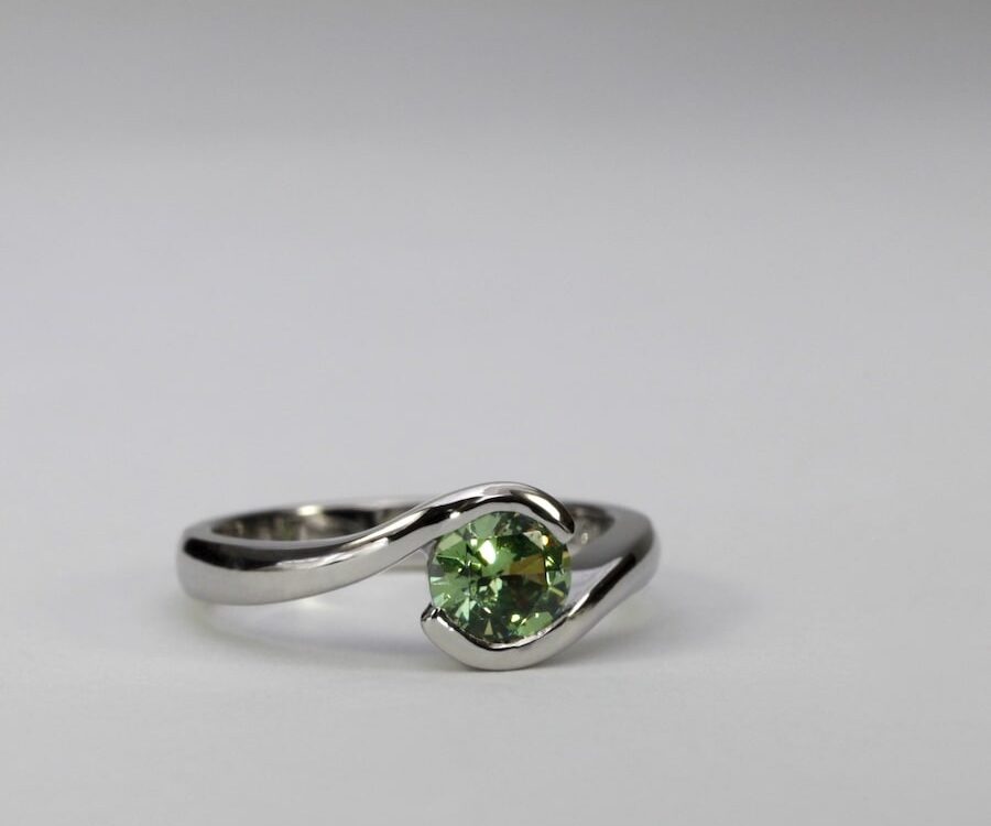 'Swell' platinum ring set with a 0.81ct demantoid garnet john miller design