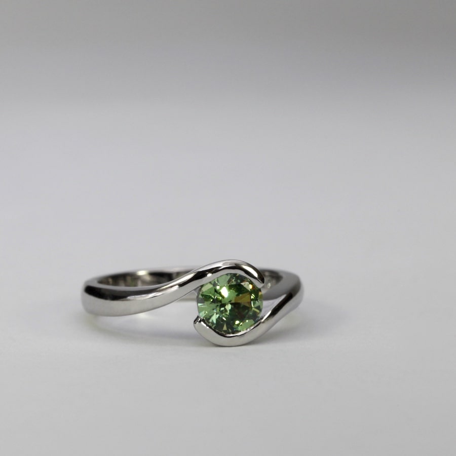 'Swell' platinum ring set with a 0.81ct demantoid garnet john miller design