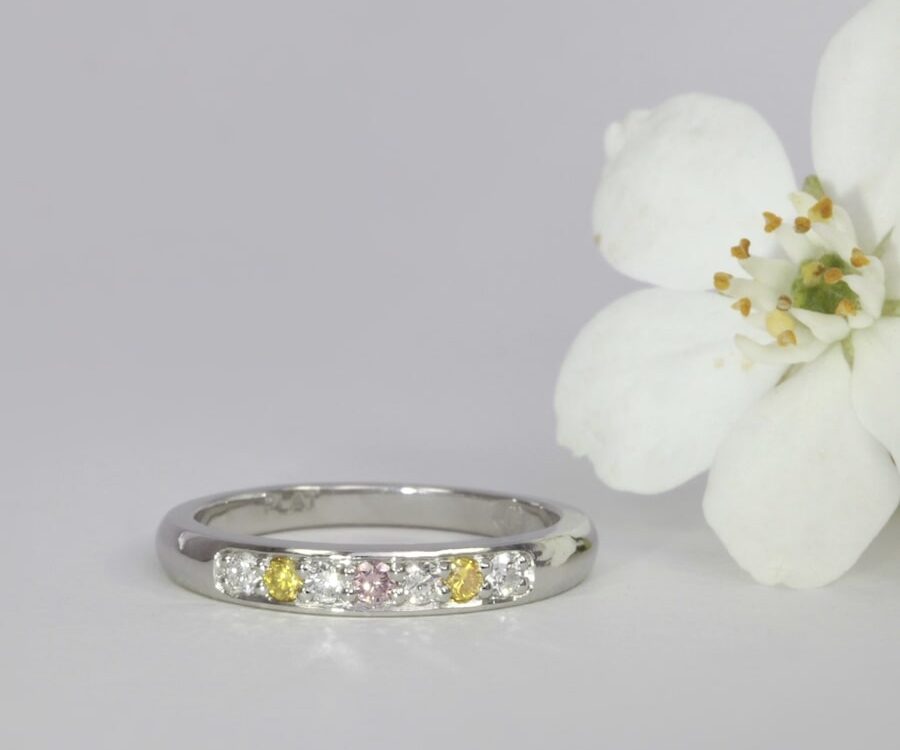 'WA Delight' platinum channel set ring with pink, yellow and white diamonds john miller design