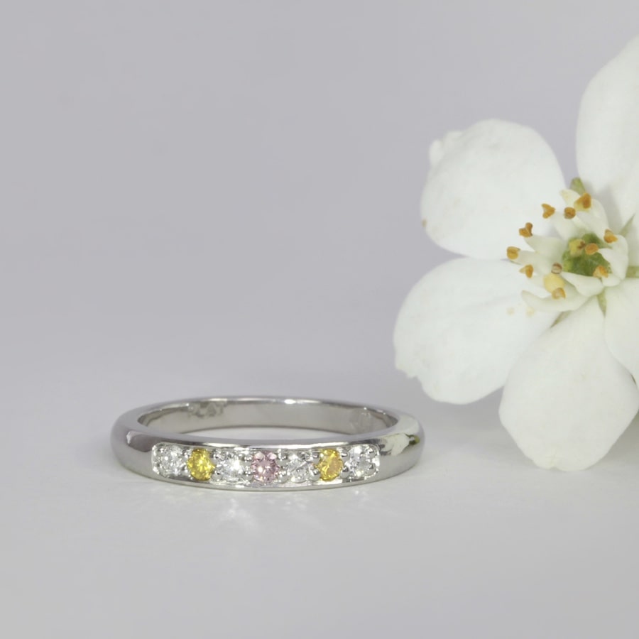 'WA Delight' platinum channel set ring with pink, yellow and white diamonds john miller design