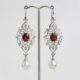 'Arabesque' platinum earrings set with 2 Spessartite garnets and 2 x 11mm southsea pearls